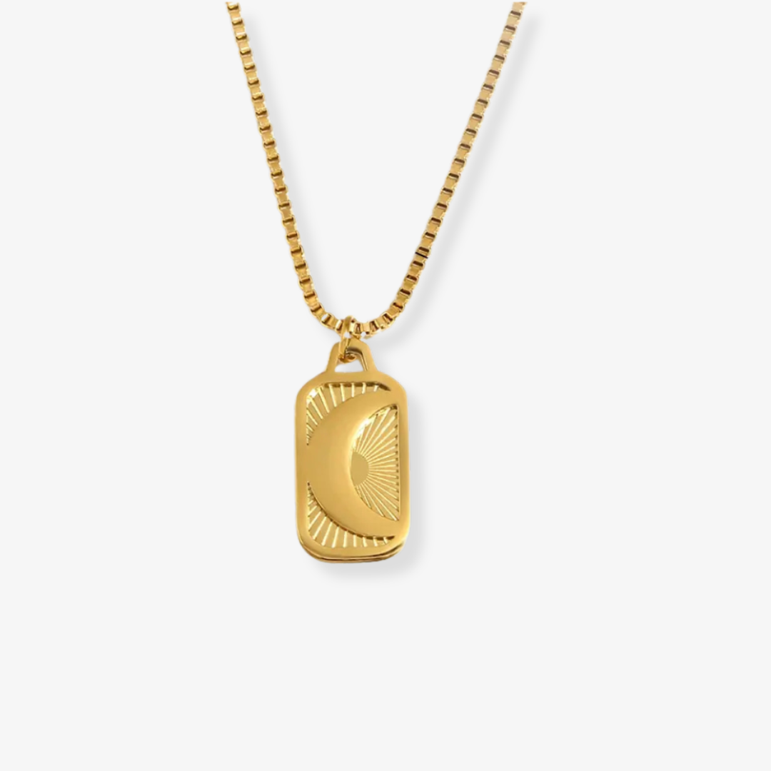 Gold necklace with a rectangular pendant on a white background