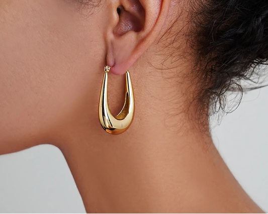Élan Earrings – Gold teardrop earrings worn on model, styled by Luzza Studio