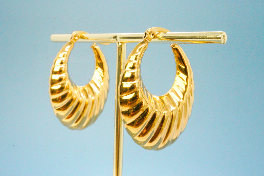 Solène Earrings – Vintage gold drop earrings on blue backdrop, minimal product shot by Luzza Studio