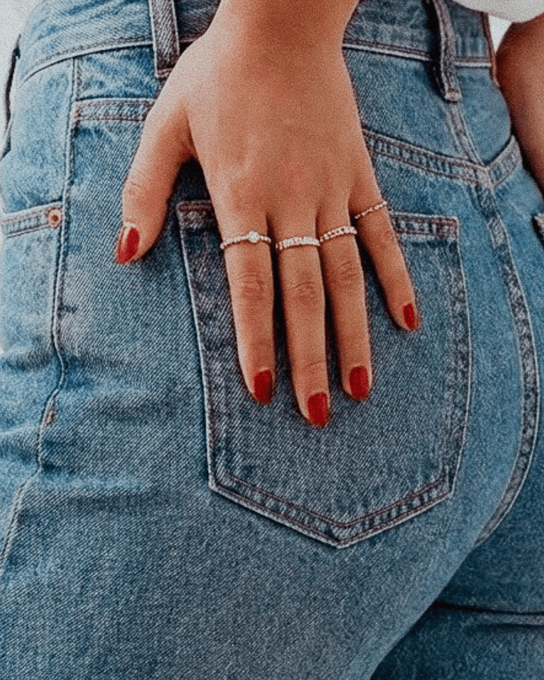 Hand wearing delicate rings from the Luzza Studio image stock