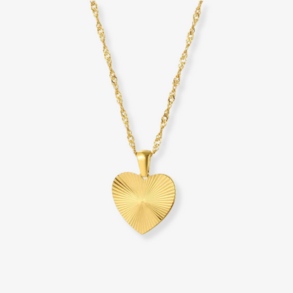 Gold heart-shaped pendant necklace on a white background