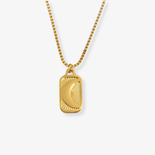 Gold necklace with a rectangular pendant on a white background