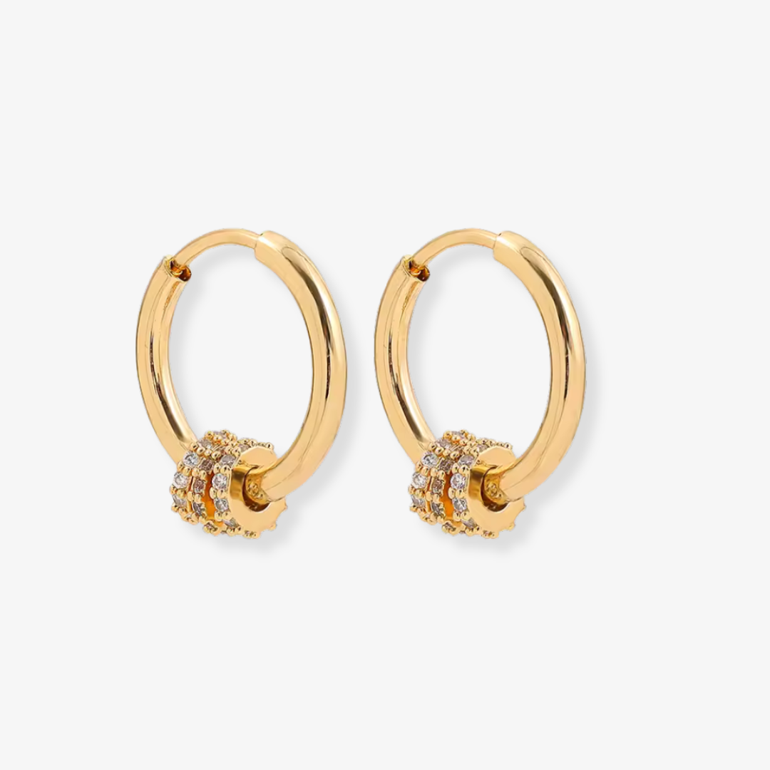 Gold hoop earrings with embedded stones on a white background