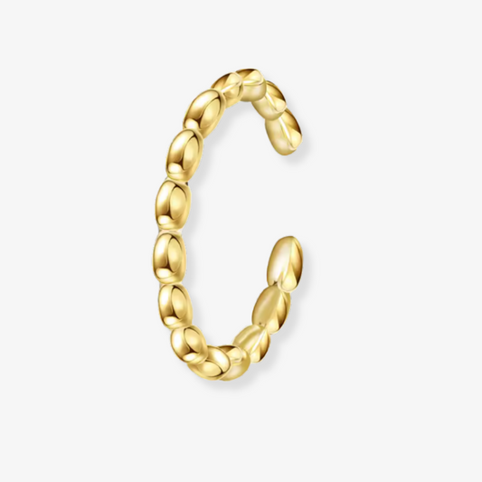 Gold hoop earring on a white background