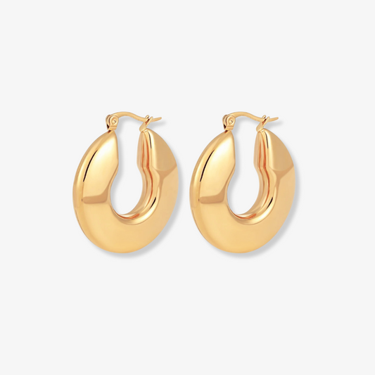 Gold hoop earrings on a light gray background
