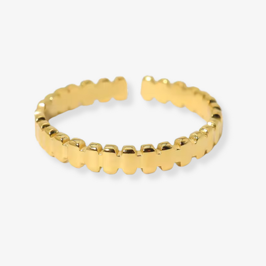 Gold ring with a textured band on a white background