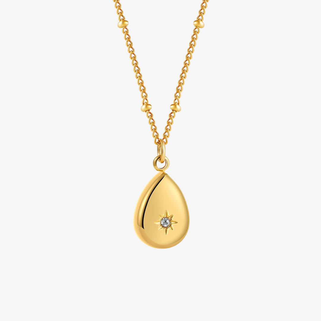 Gold teardrop pendant necklace on a white background