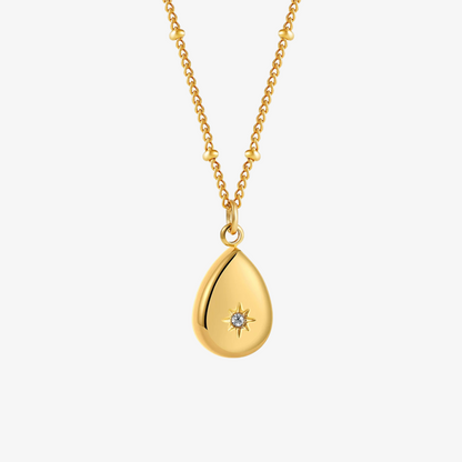 Gold teardrop pendant necklace on a white background