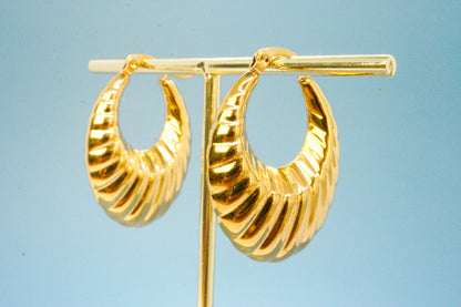 Solène Earrings – Vintage gold drop earrings on blue backdrop, minimal product shot by Luzza Studio	