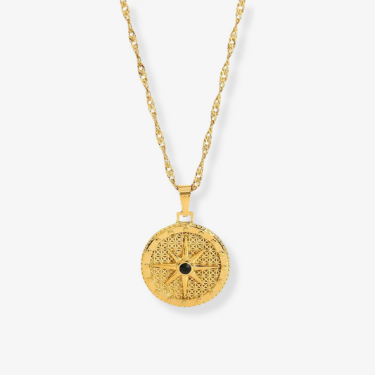 North Star Necklace – Gold compass medallion with black enamel on white background by Luzza Studio
