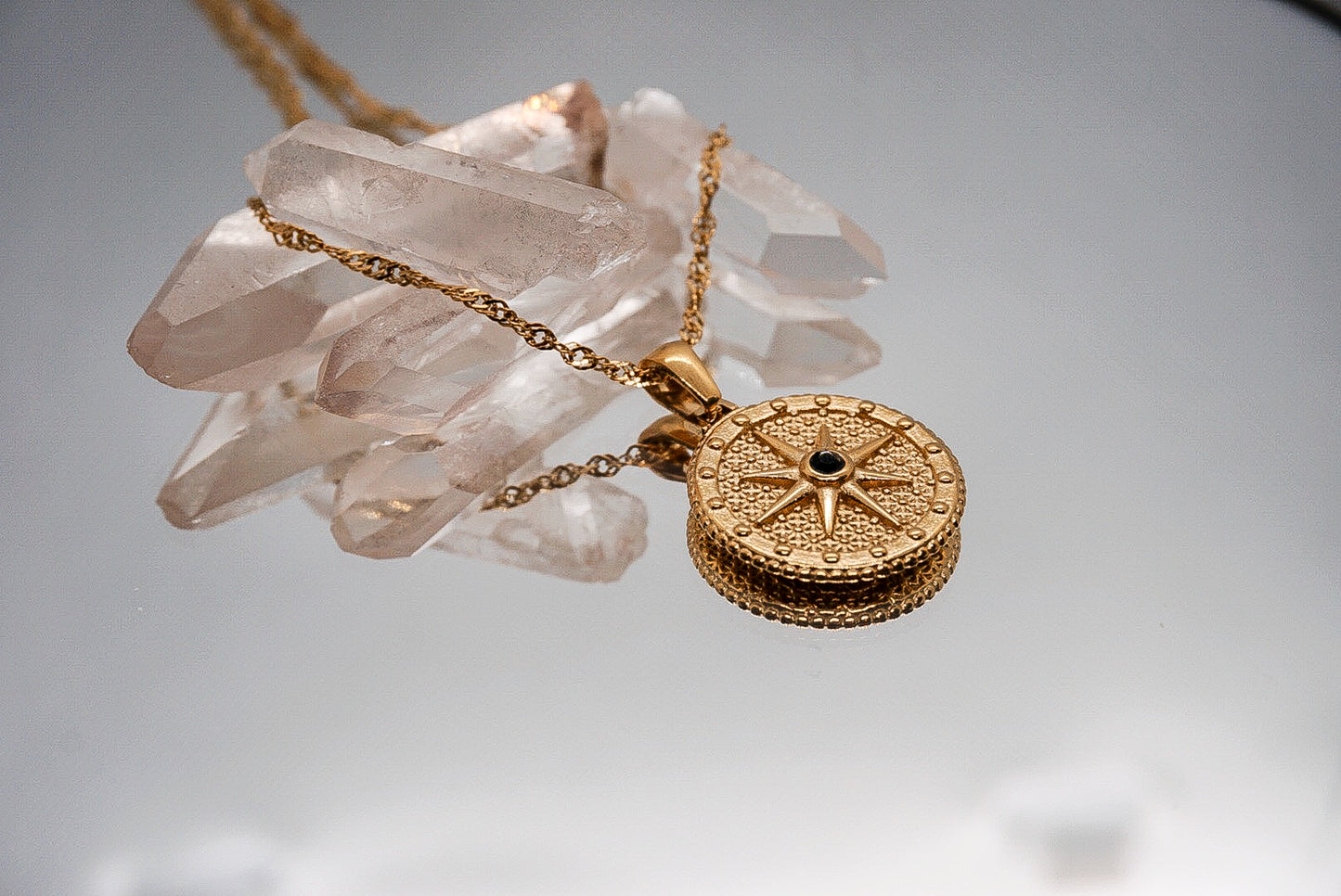 North Star Necklace – Gold compass rose pendant styled in celestial flatlay by Luzza Studio

