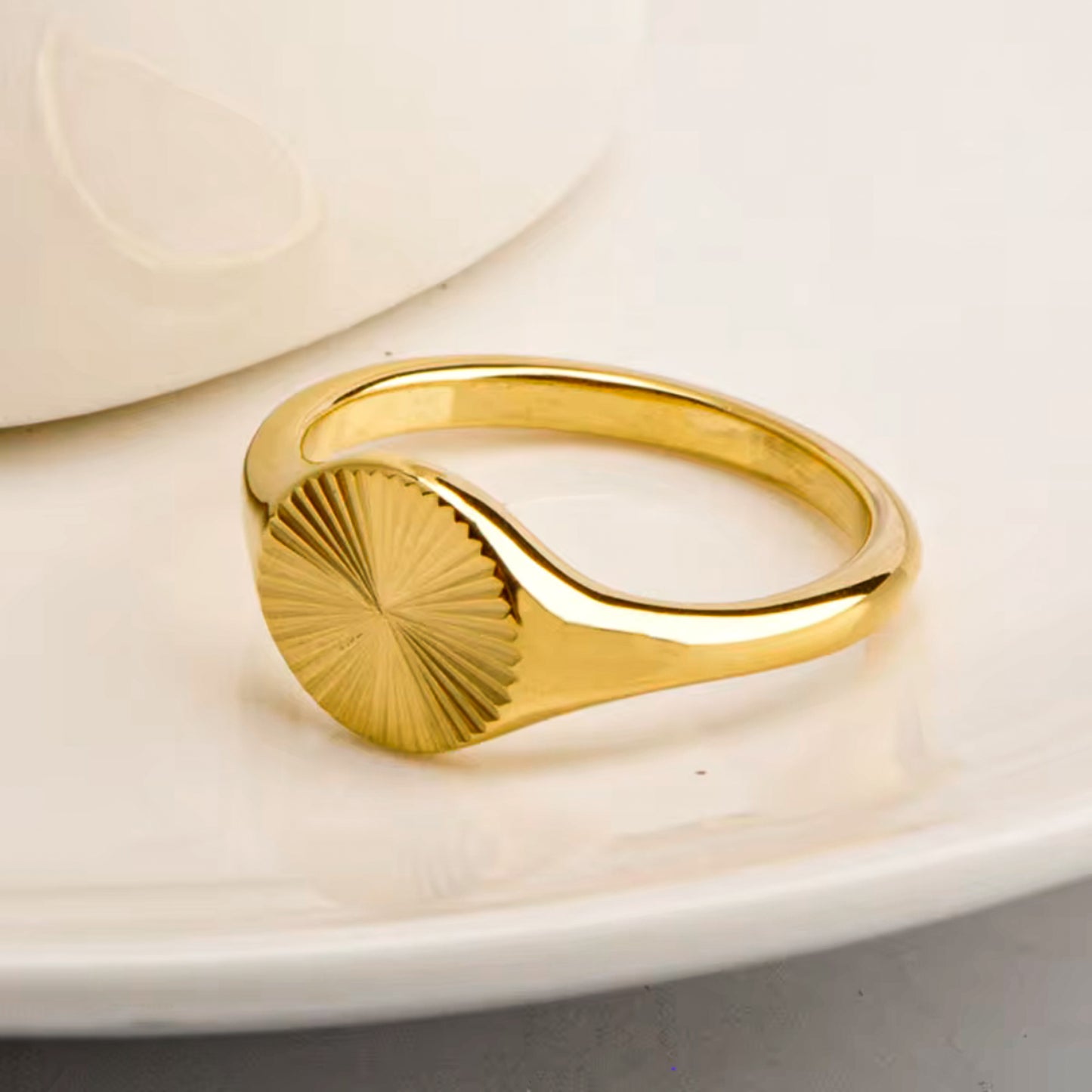 Orla Ring – Sculptural gold ring styled on soft background by Luzza Studio

