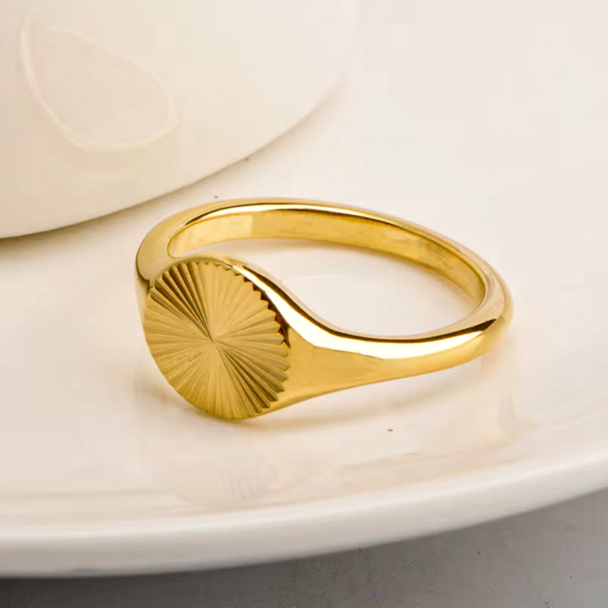Orla Ring – Sculptural gold ring styled on soft background by Luzza Studio

