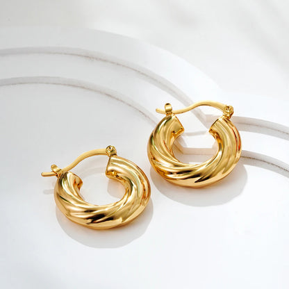 Pair of gold hoop earrings on a white background