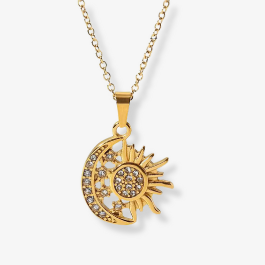 Soluna Necklace – Gold sun and moon pendant with rhinestones on white background by Luzza Studio
